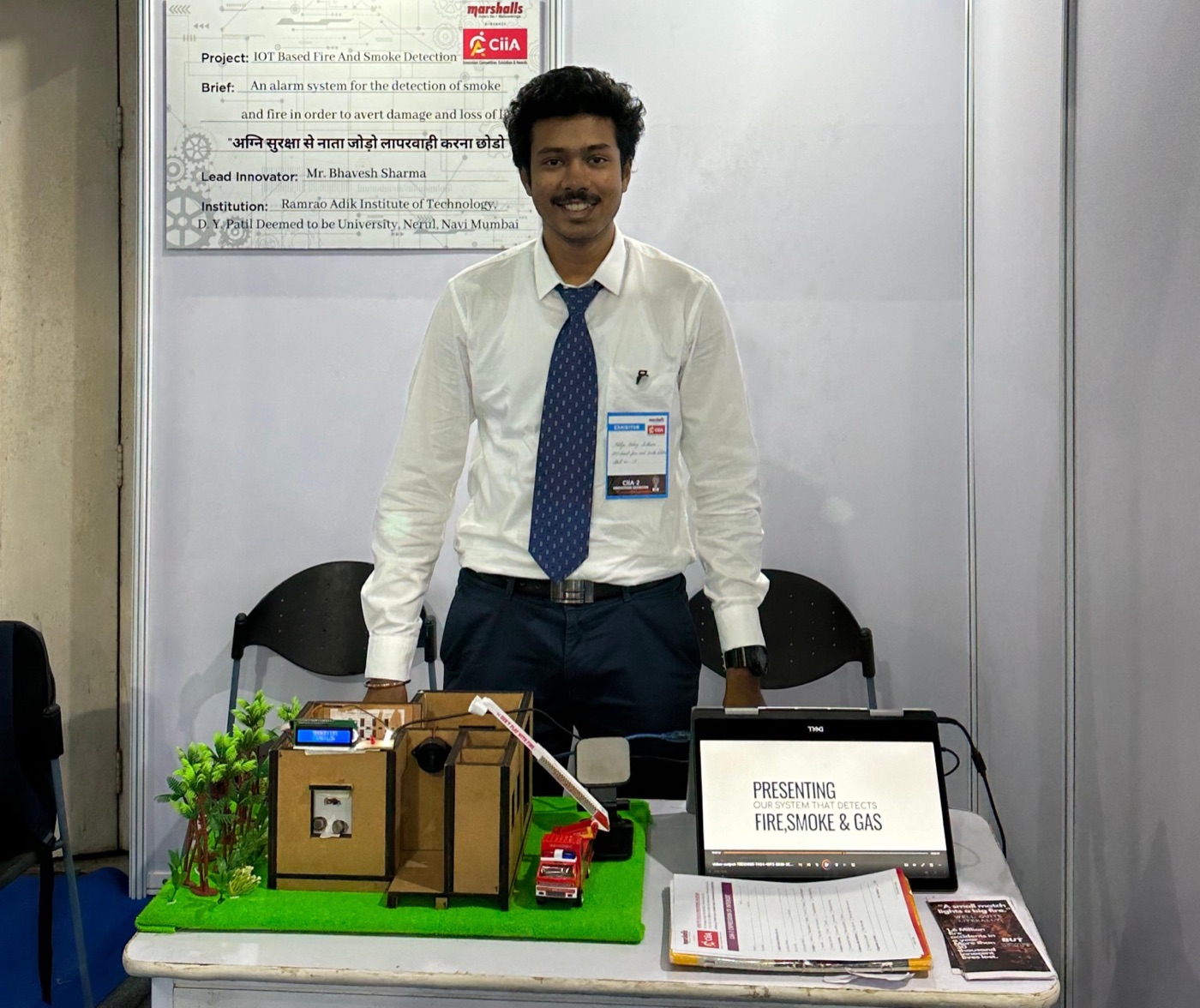 Aditya presenting the SafeSense fire and smoke detection prototype at the CIIA exhibition